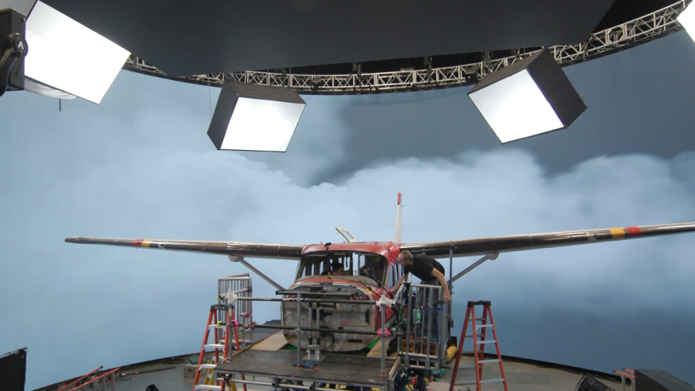 The crew prepares to film the Cessna flying through clouds